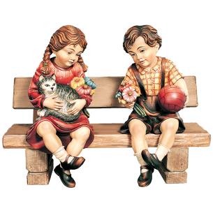 Boy and girl sitting on bench